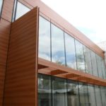 Навесные оранжевые фасадные панели для обустройства здания